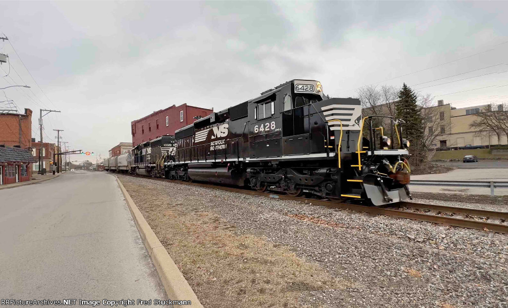 NS 6428 leads the local out of town on its way south.